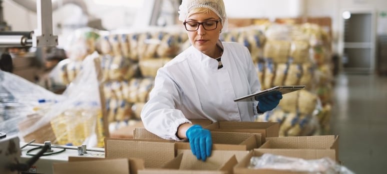 Woman inspecting supply chain boxes-1
